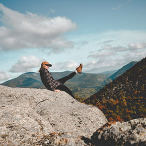 Person standing on a cliff, ready to leap, symbolizing courage and personal transformation