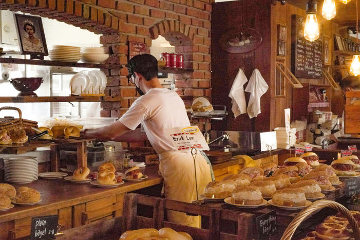 Angajat pregătește produse de patiserie într-o brutărie