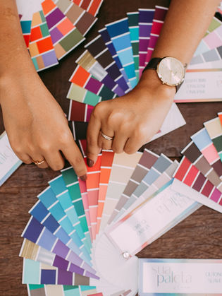 Someone with color swatches on a table