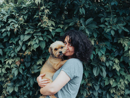 A person holding a small dog