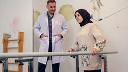 Patient working with a physiotherapist during joint rehabilitation after surgery.