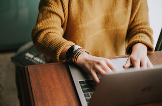 Professional using a laptop to contact Rosi Legal for contract drafting, compliance advice, and business legal support.