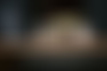 Digital clock showing 11:30, beside essential oil box, camera, and cotton swabs on wooden shelf. Text in Japanese, calm setting.