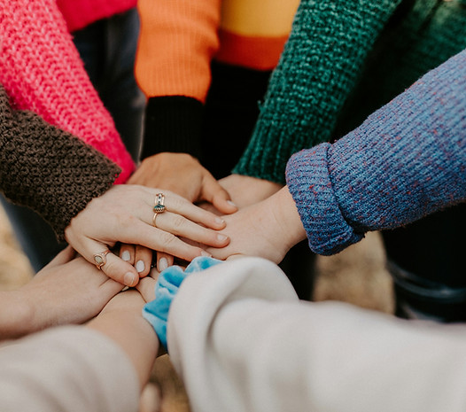 Photo of people putting their hands all in and on top of each other