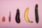 different vegetables with condoms on top of them.