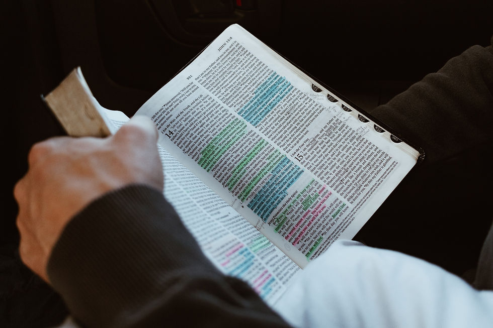 Hands holding an open Bible with highlighted verses explaining Christian FAQs about forgiveness, heaven and eternal life.