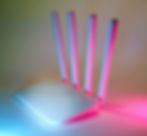 white wireless router with blue and pink lights