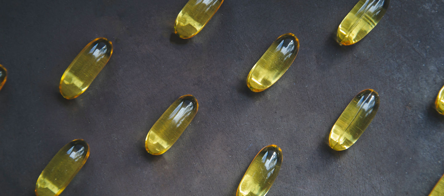 Omega-3 capsules on a dark background