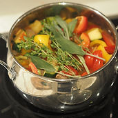Silver pot of soup with mixed vegetables