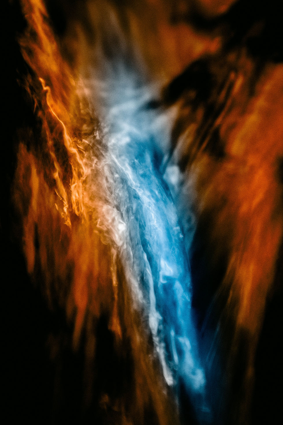 a blending of blue and orange flowing shapes, resembling flames or water.
