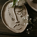 Clay mask representing somatic attachment therapy and embodied healing approaches. Allison uses Embody Lab somatic techniques to help clients reconnect with their bodies through guided meditations, gentle movement, and body-based trauma recovery. Virtual somatic therapy available across Texas, New Mexico, Florida, Idaho, and Arizona for LGBTQ+, neurodivergent, and eating disorder recovery