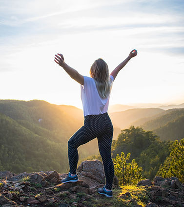 A woman with hands raised up in victory