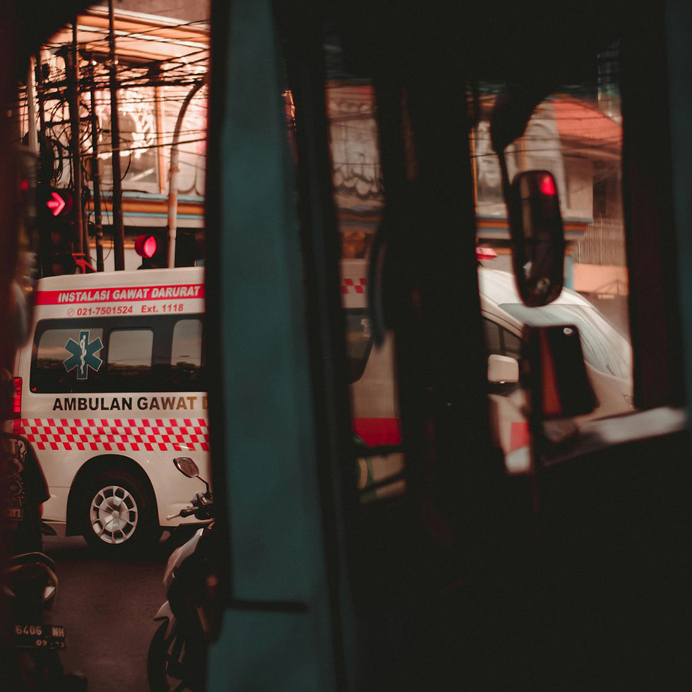 Ambulance with "Ambulan Gawat" text drives through a busy street, framed by vehicle interiors. Red and white color theme with urban backdrop.