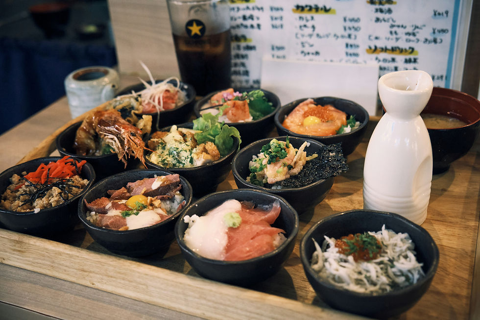 Small bowls of assorted seafood and rice for a Travel Guide Japan.