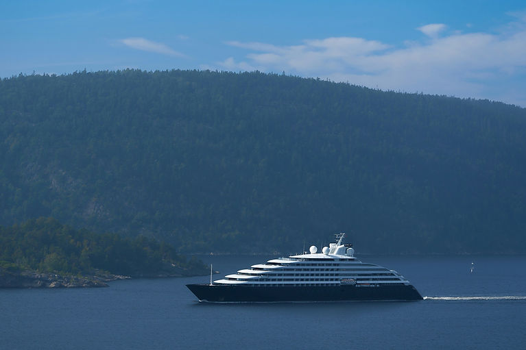 Luxury ocean cruise ship sailing through a scenic coastal destination