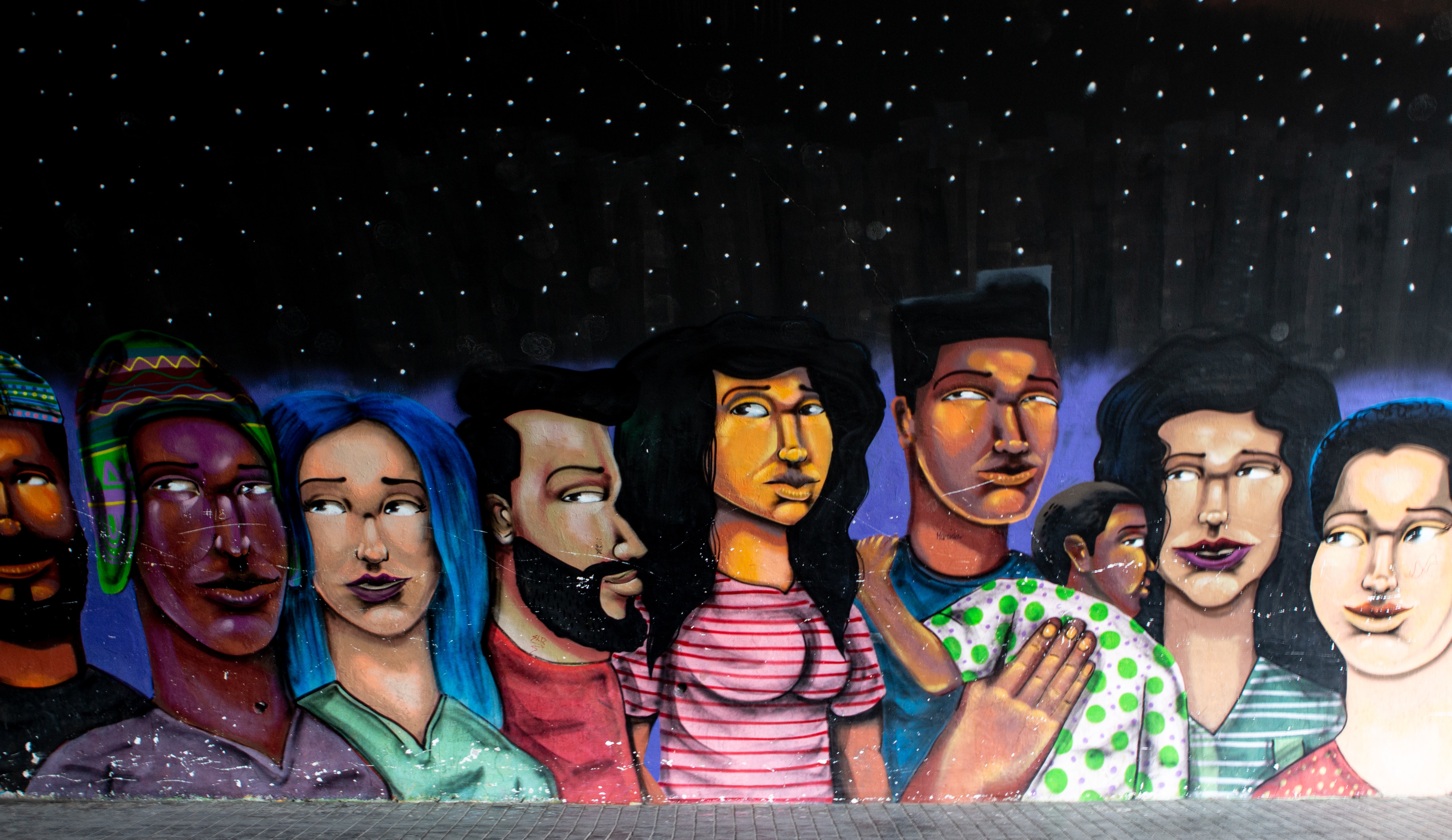 mural of multicultural people with stars above them