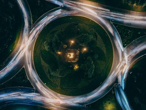 Time-lapse image of traffic looping through a roundabout, representing repetitive thought cycles