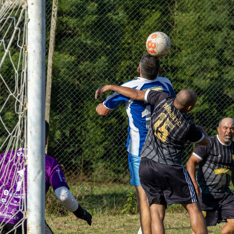 Football players competing for a header on goal under match pressure - training tips for Bournemouth and Poole football players.