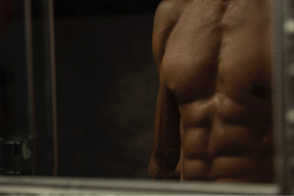 Guy with a six pack standing in mirror