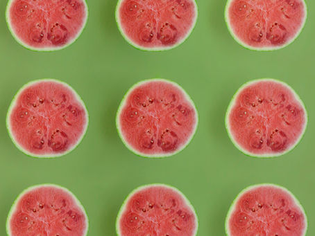 Sliced watermelons on a green background