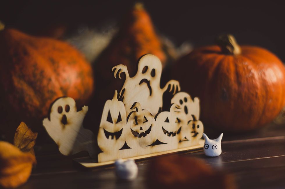 Pumpkins and ghosts carved out of wood