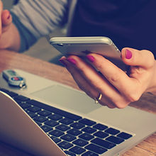 customer with phone and laptop making a booking