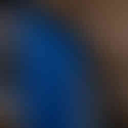 An arched stone doorway with a deep blue-painted wooden door, characteristic of the mystical architecture in Tzfat, Israel.