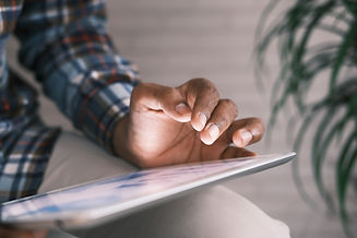 Image of a hand interacting with a tablet screen