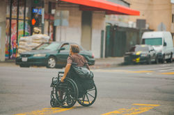 Wheelchair user on an urban accessible street