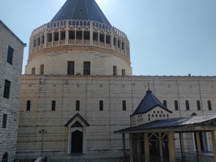 External view of the brutalist limestone architecture and the towering dome of the Basilica of the Annunciation in Nazareth.