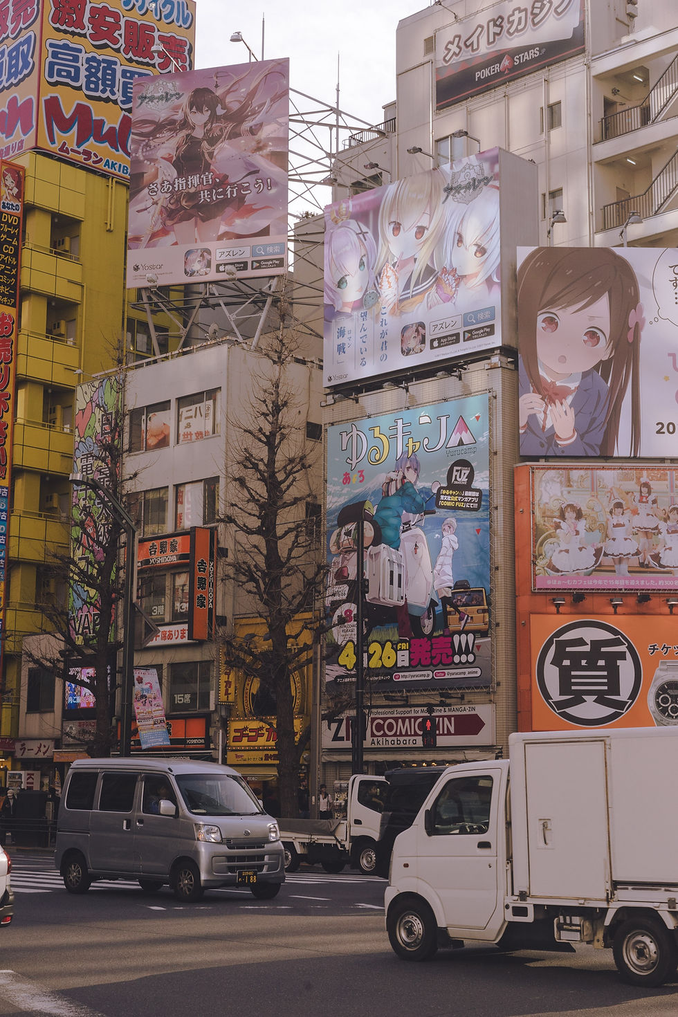 a city street filled with anime billboards