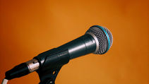 A microphone against an orange background