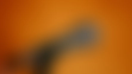 A microphone against an orange background