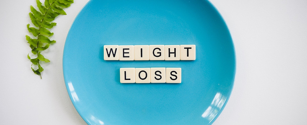 Scrabble tiles used to spell the word weight loss on a plate