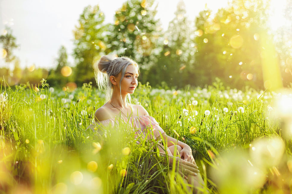 Woman sat in wildflower field in spring