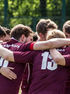 Group of football players embracing in a team huddle, showing friendship, support, teamwork, and connection.