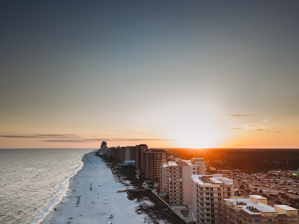 Sunset over coastal buildings and beach