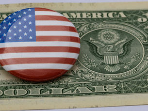 dollar bill with american flag pin on it