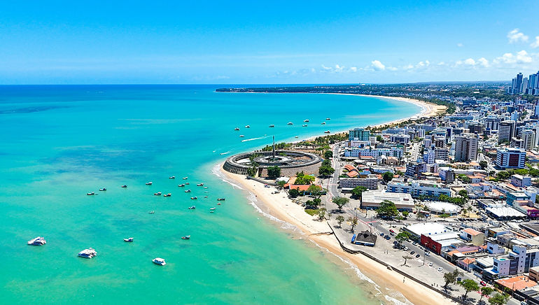 Aerial view of the coast of Joao Pessoa meeting a clear turquoise ocean