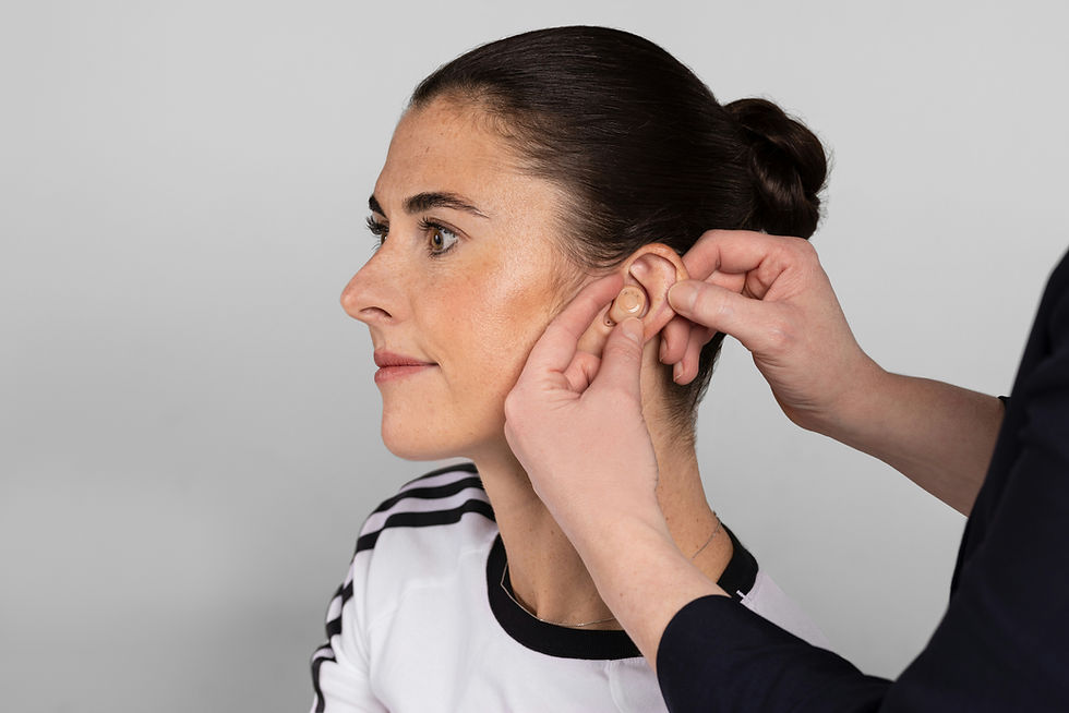 Close-up view of an ear with a hearing aid inserted