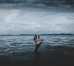 image of hand in sea looking like someone is drowning