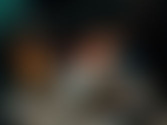 a happy couple on a fall date night roasting smores and enjoying each others company next to a lantern with candles in it.