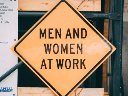 Sign saying "Men and Women at work" to symbolize a diverse leadership team