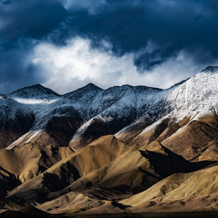 Snow-capped Ladakh mountains under dramatic winter sky — Global Journeys Ladakh travel guide
