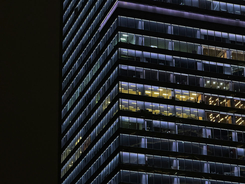 Commercial office building exterior at night, highlighting floor-by-floor occupancy and stacking visibility.