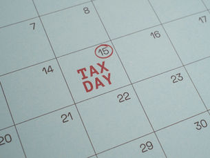 calendar with april 15th showing and tax day written on it