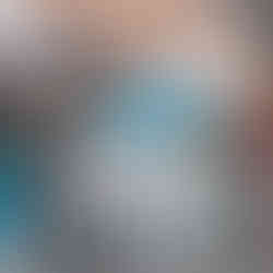 A local cyclist riding through the narrow stone alleys of the Carmel Market in Tel Aviv, showing the urban life of the city.