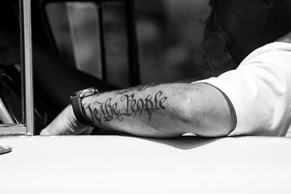 We the People tattoo on forearm - remembering the founders' vision of balanced freedom and responsibility