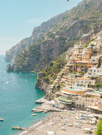 The town of Positano on the Amalfi Coast next to a sea filled with boats.