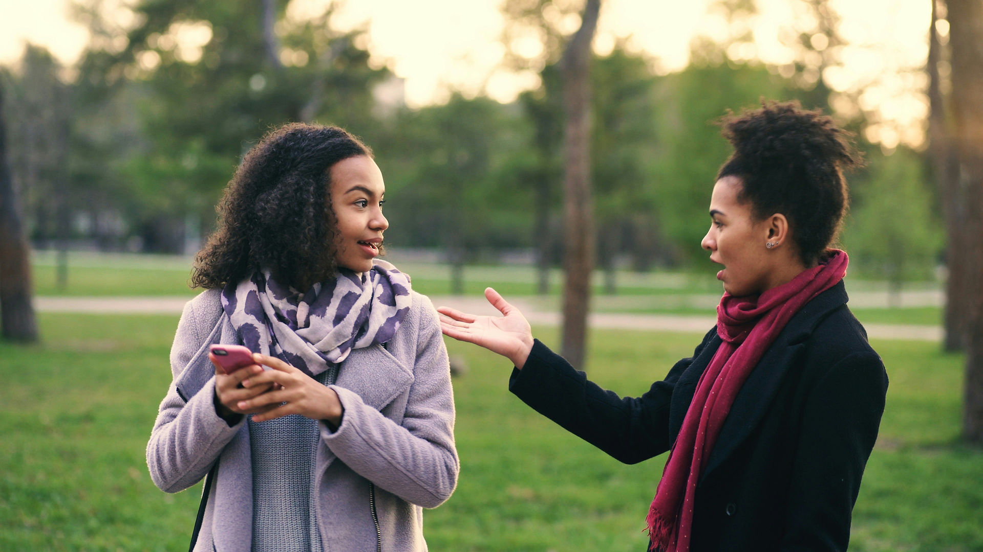 Two people chatting in a park.